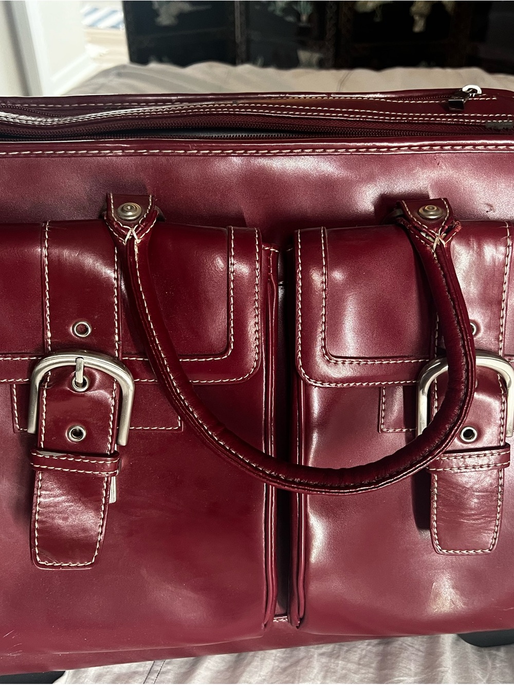 Burgundy Franklin Covey rolling laptop briefcase with matching zipper pouch.